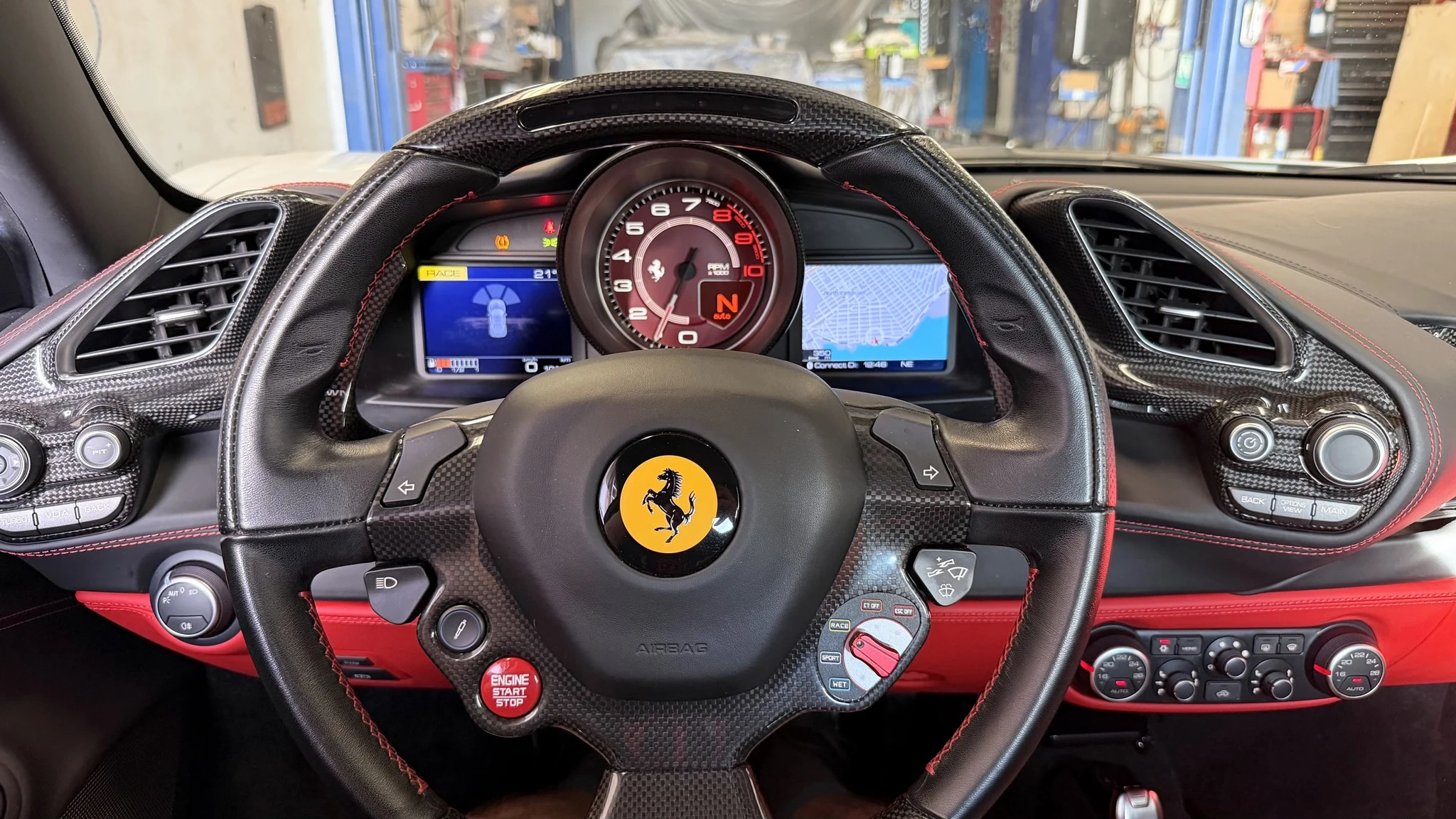 After repair: the Ferrari’s instrument cluster reinstalled with the right-hand display showing the navigation map