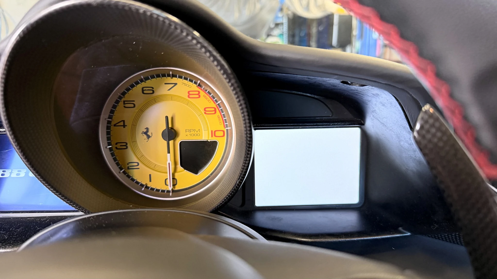 Before repair: the Ferrari’s right-hand instrument-cluster LCD showing a blank white screen